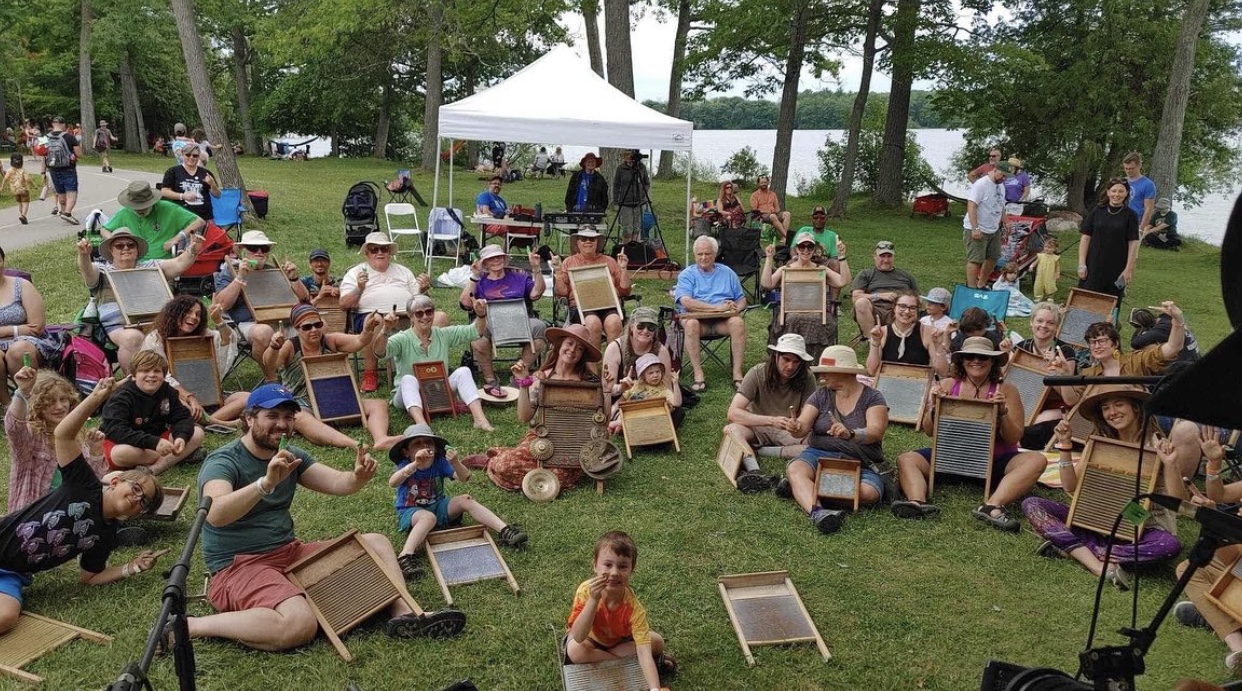 A washboard workshop on the lawn by the lake, all thumbs up