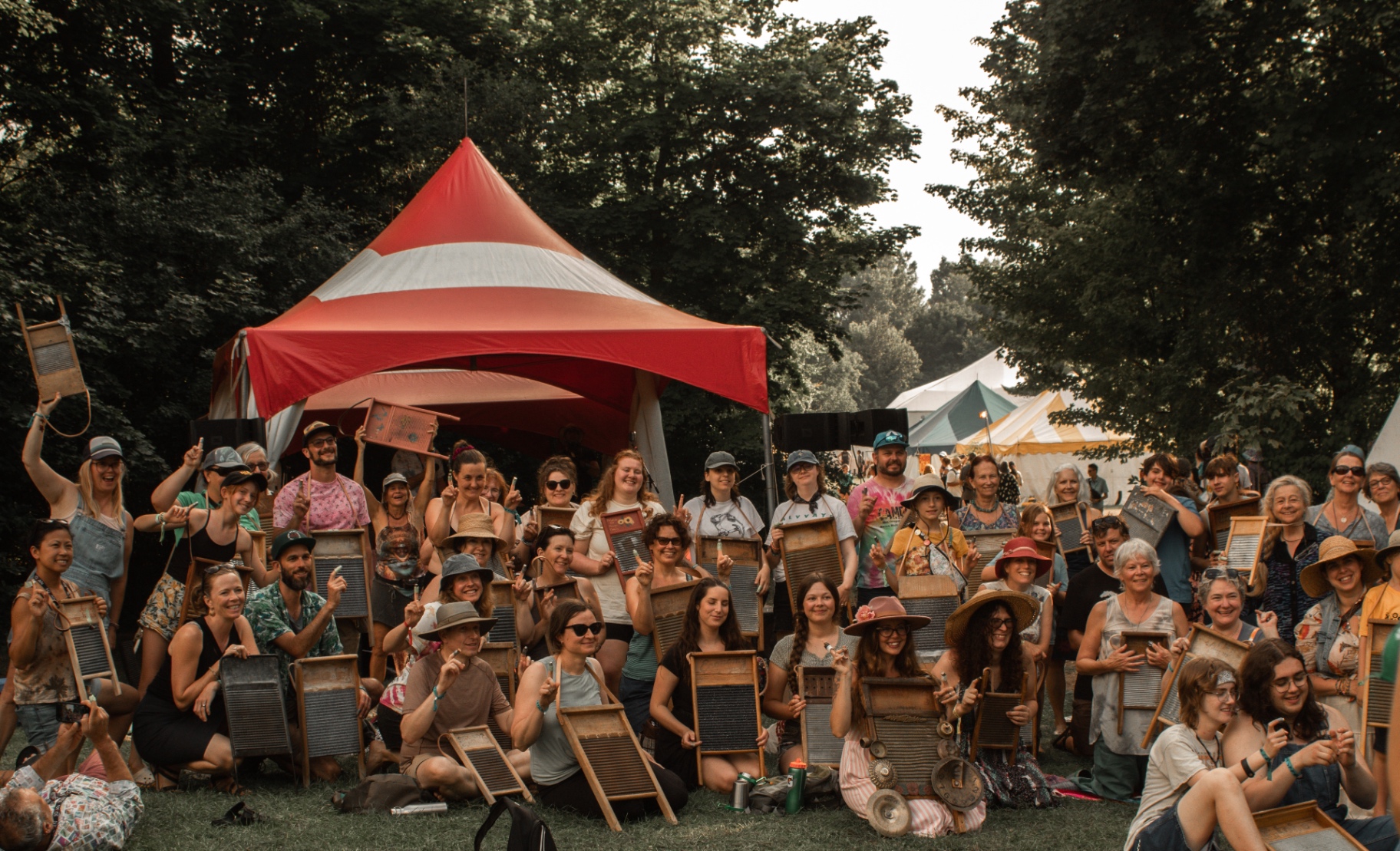 A big group photo with washboards raised under the red festival tent