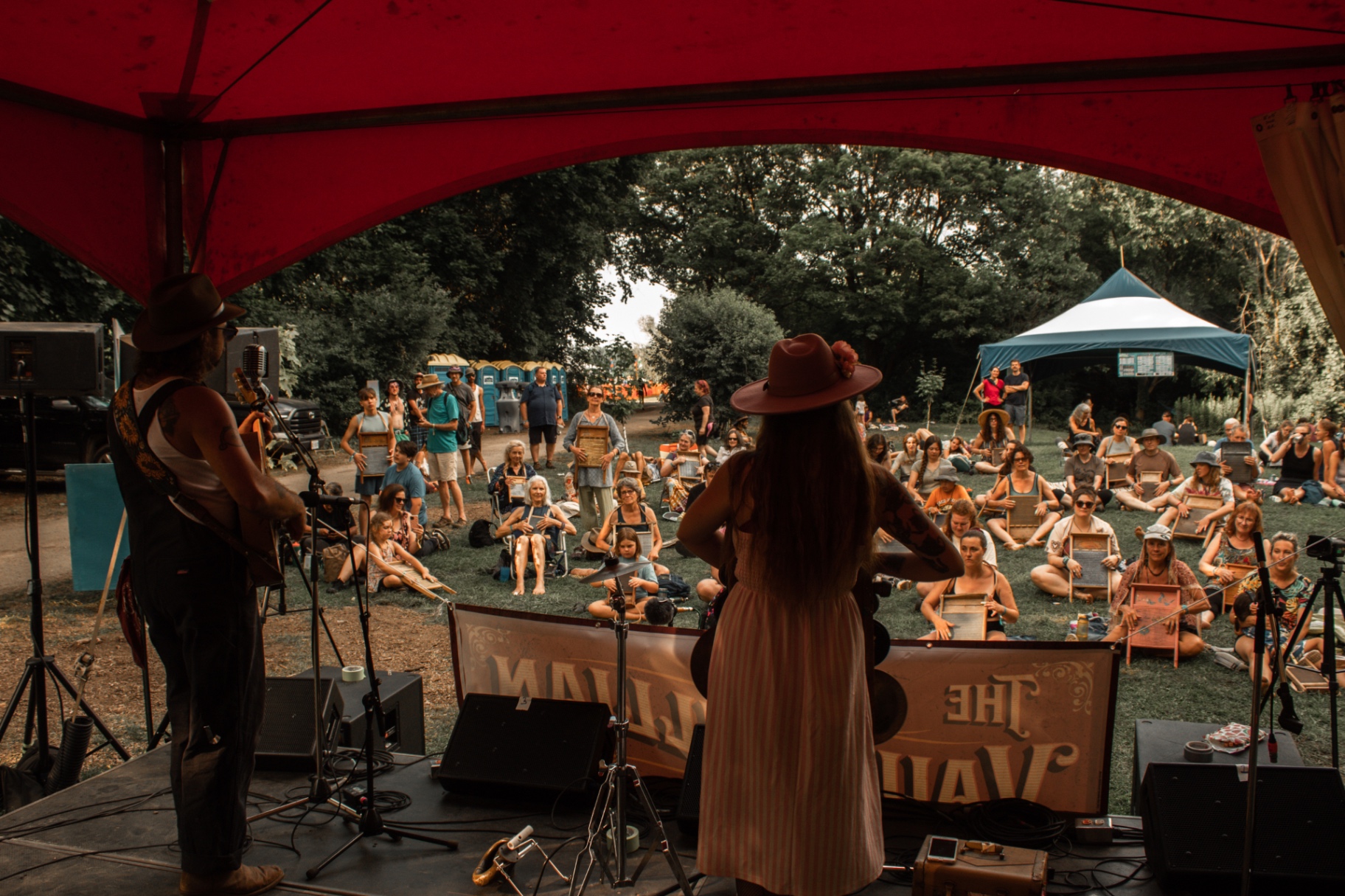 Norah Spades leading a workshop as the crowd raises their spoons