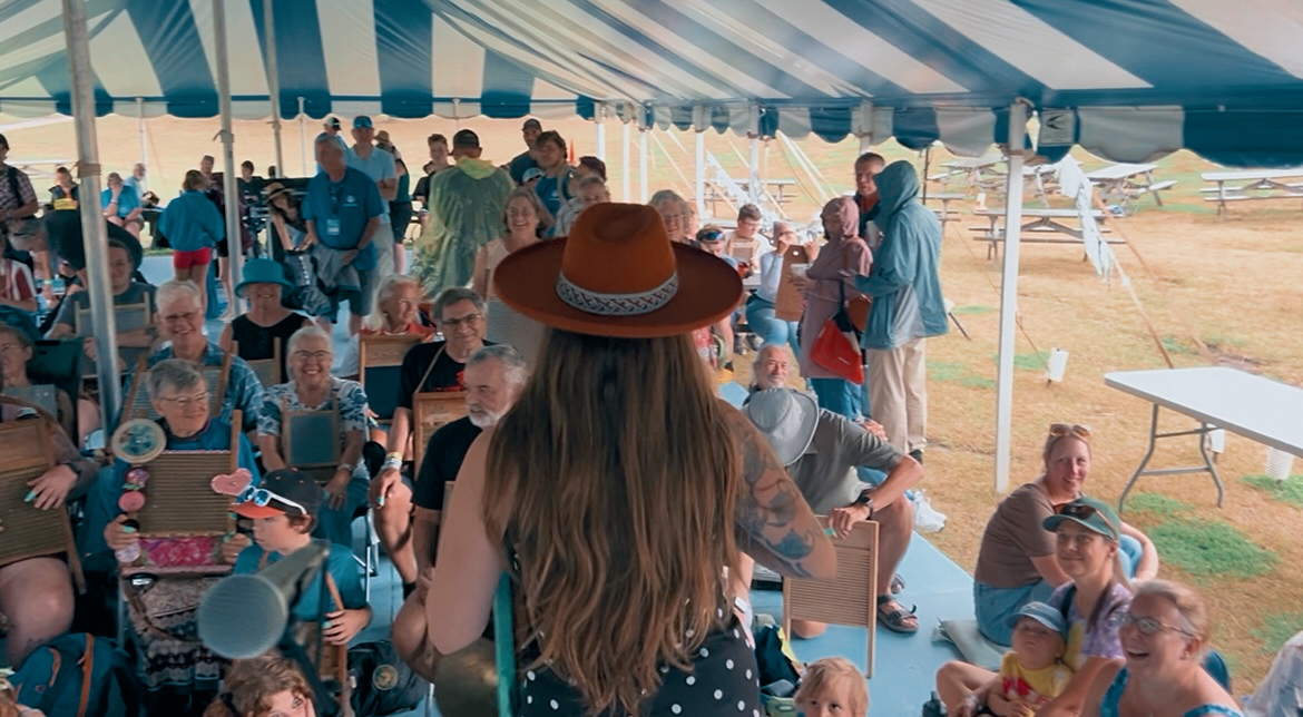 Norah Spades leading a workshop under the striped festival tent